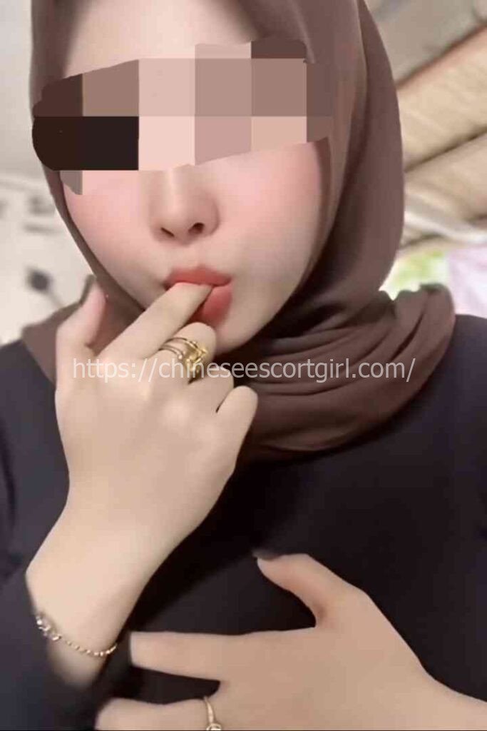 Zana, 22yo Malay GFE escort in KL, posing with her hand on her chest